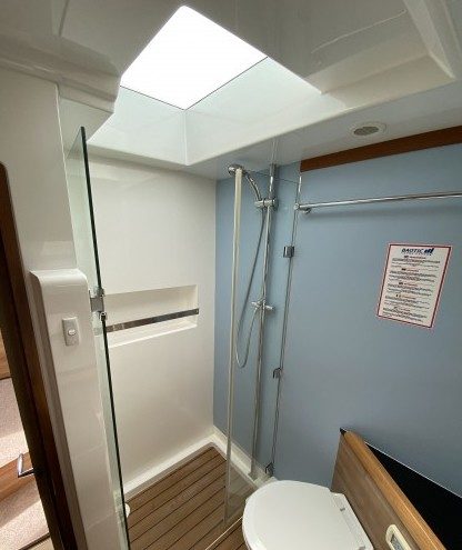 Head with shower and overhead skylight